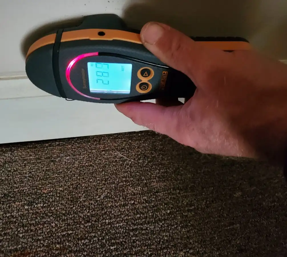 Moisture detection at baseboard during Storm Damage Restoration in Tiffin